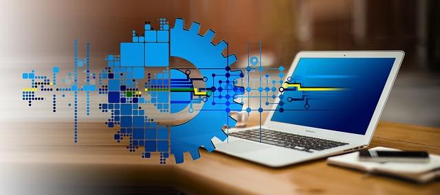Image shows a laptop and cog representing digital transformation